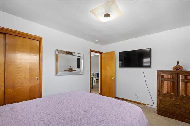 a bedroom with a bed and a television