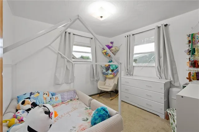 a bed room with furniture and a window