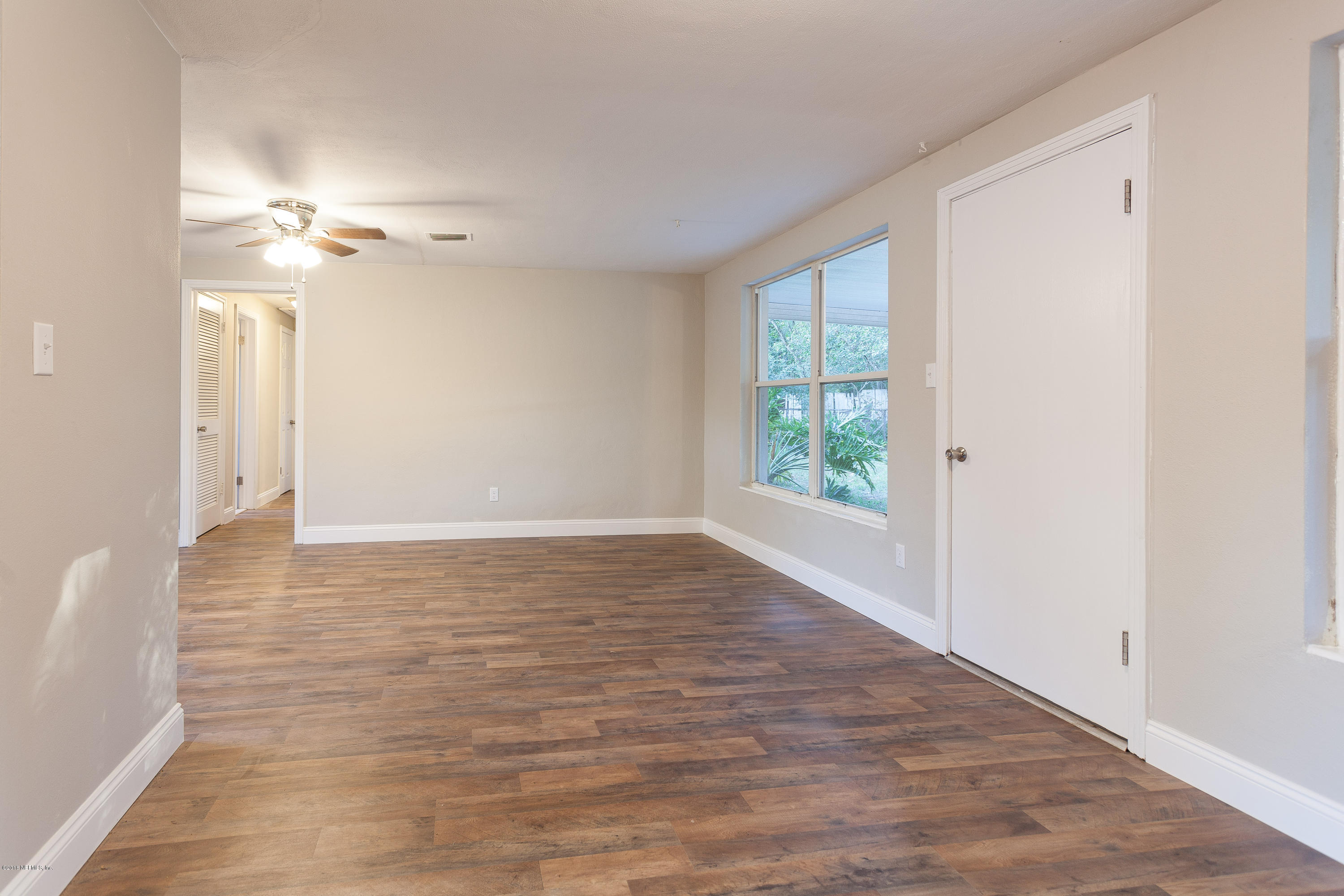 4230 Springwood Road Jacksonville, FL 32207 - Photo 11 of 20 wooden floor in an empty room with a window