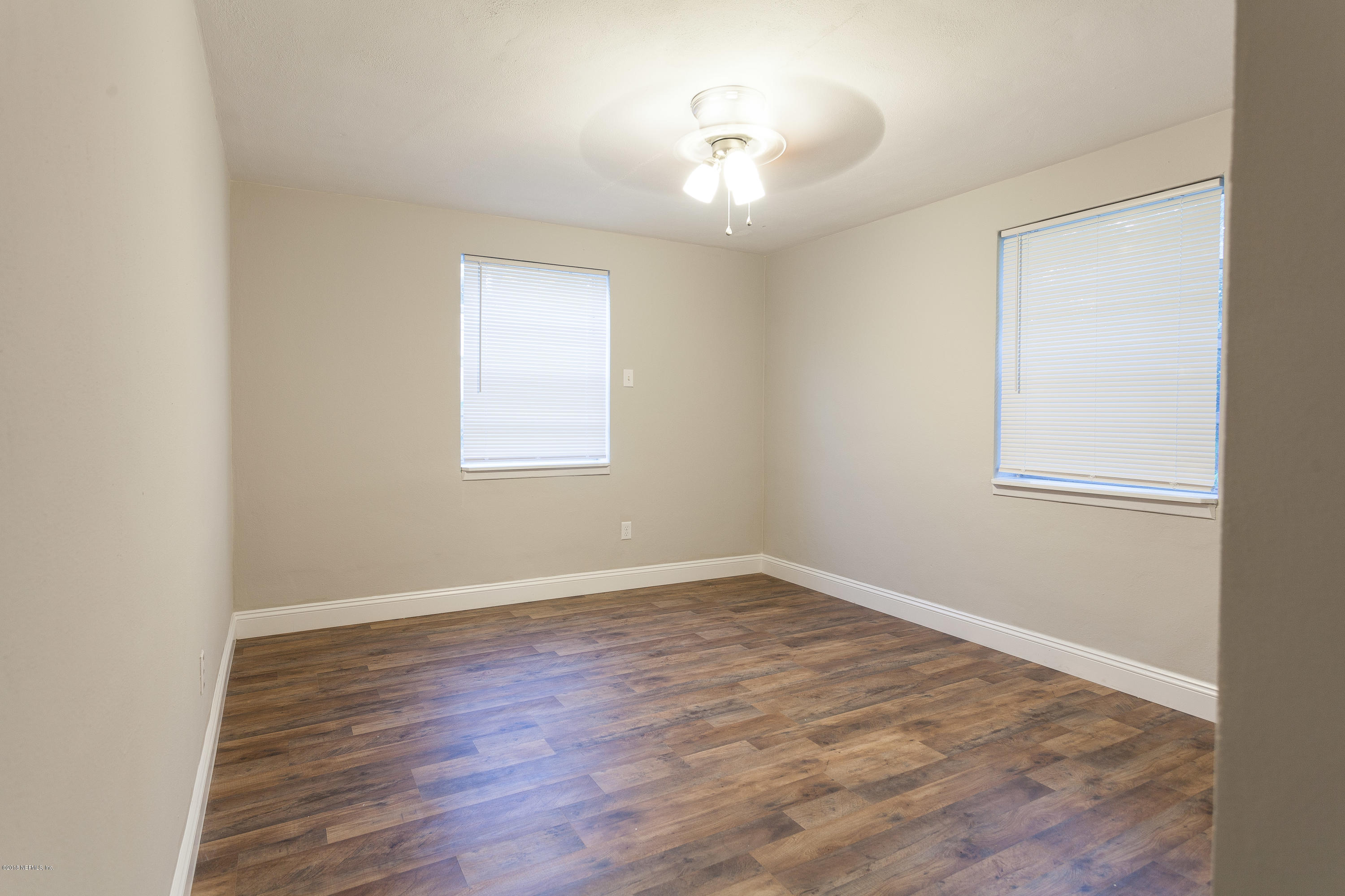 4230 Springwood Road Jacksonville, FL 32207 - Photo 17 of 20 an empty room with wooden floor and windows