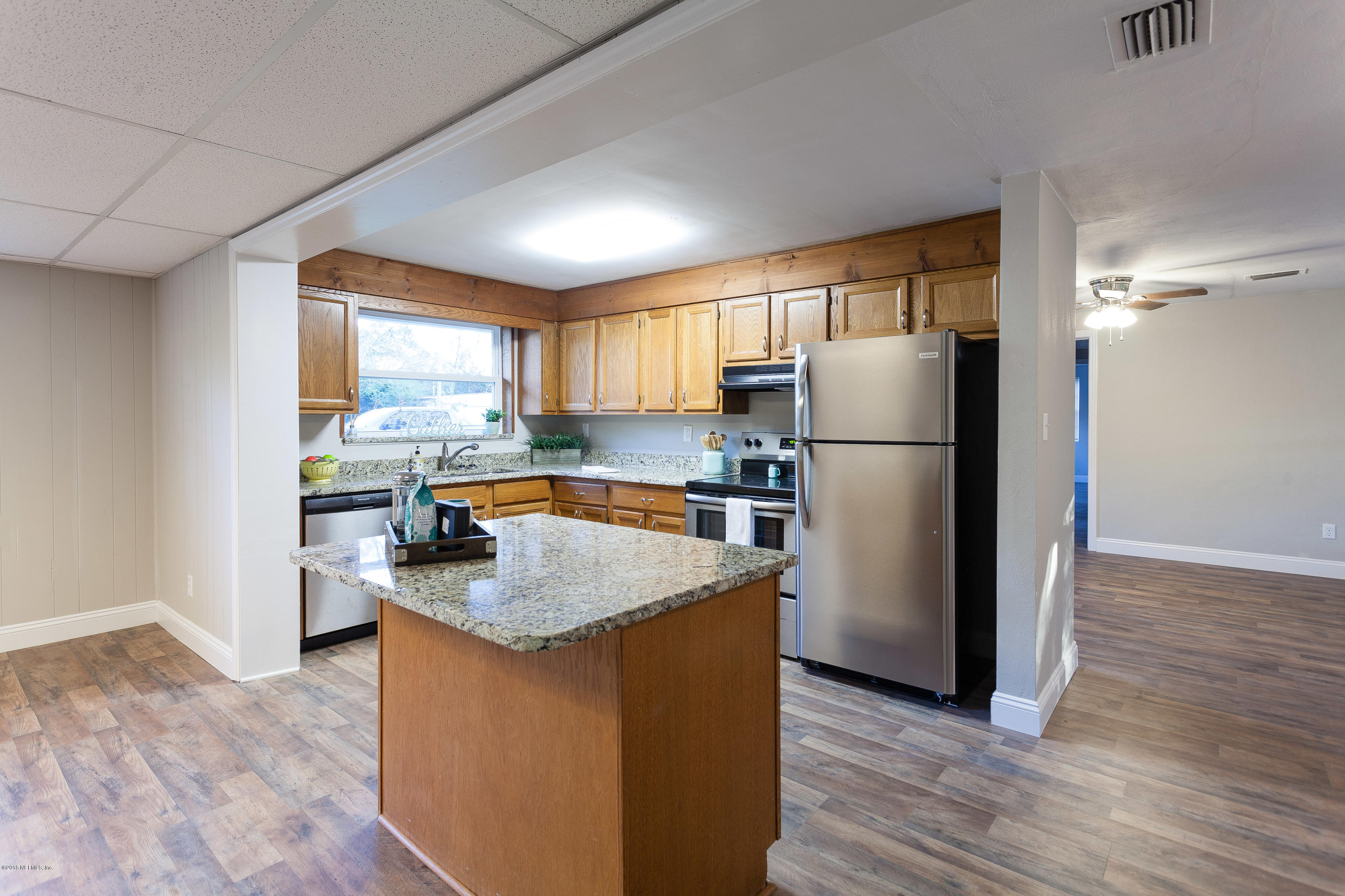 4230 Springwood Road Jacksonville, FL 32207 - Photo 6 of 20 a kitchen with refrigerator cabinets and wooden floor
