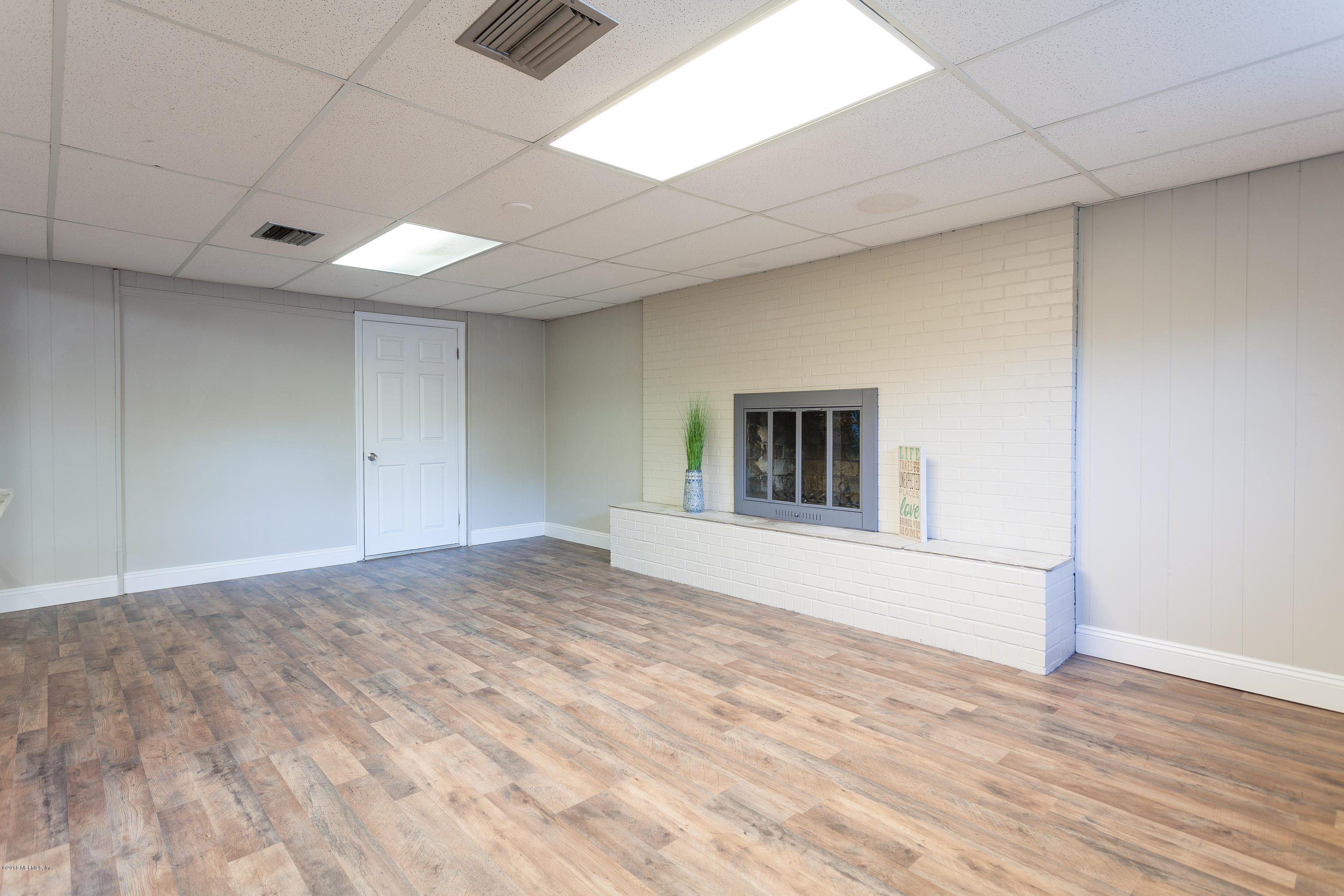 4230 Springwood Road Jacksonville, FL 32207 - Photo 9 of 20 a view of empty room with wooden floor and fan