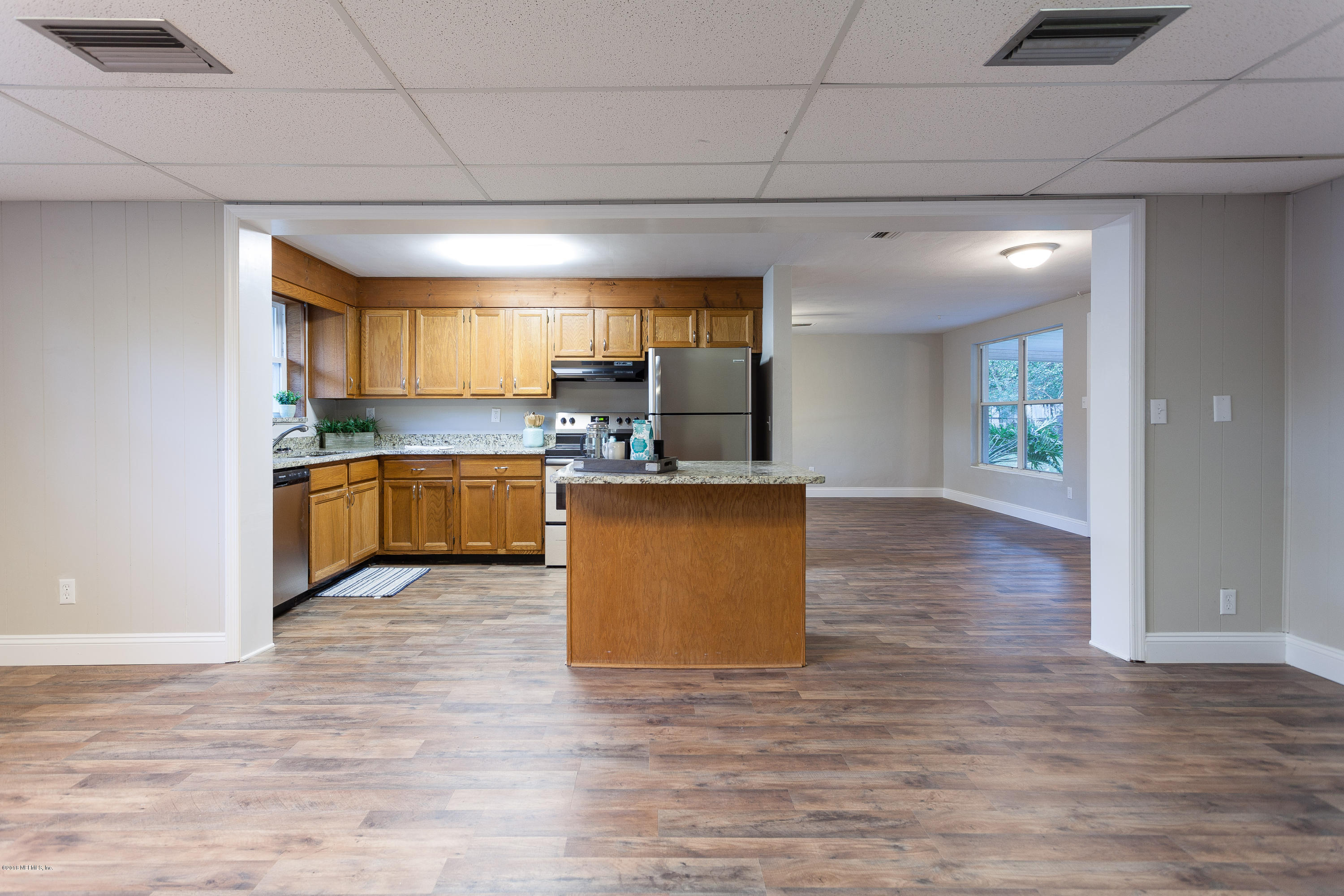 4230 Springwood Road Jacksonville, FL 32207 - Photo 10 of 20 a kitchen with stainless steel appliances granite countertop a sink and cabinets with wooden floor