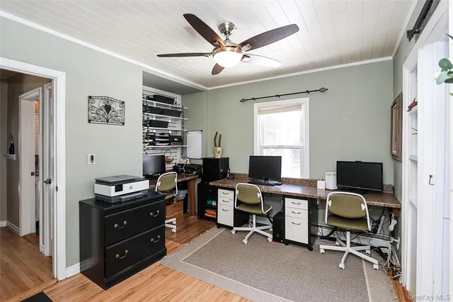 a view of a workspace with furniture and a window