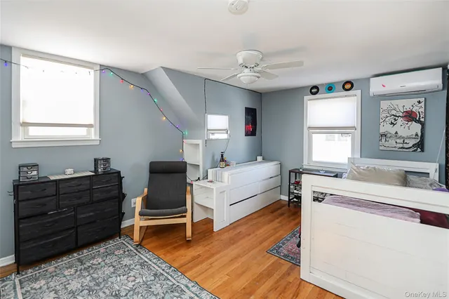 a living room with furniture and a dresser