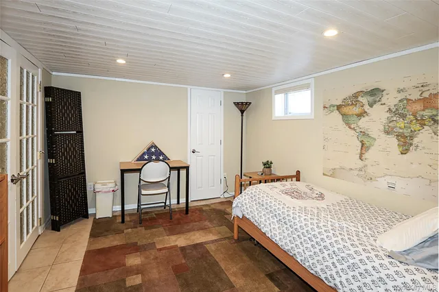 a bedroom with a bed and a painting on the wall