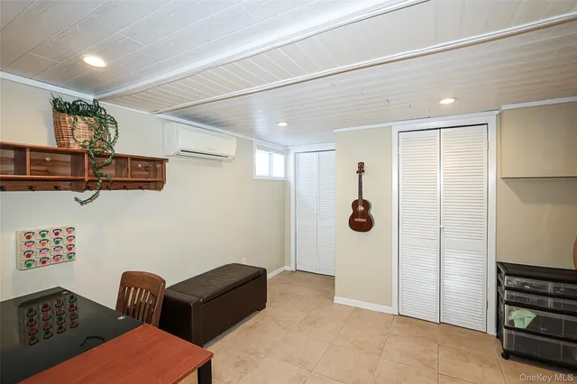 a walk in closet with wooden floor