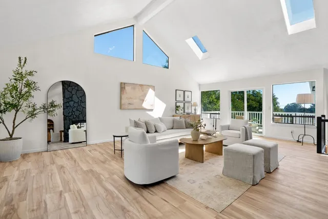 a kitchen with stainless steel appliances granite countertop a stove a sink and white cabinets