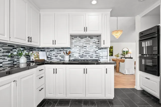a kitchen with stainless steel appliances a sink stove and cabinets