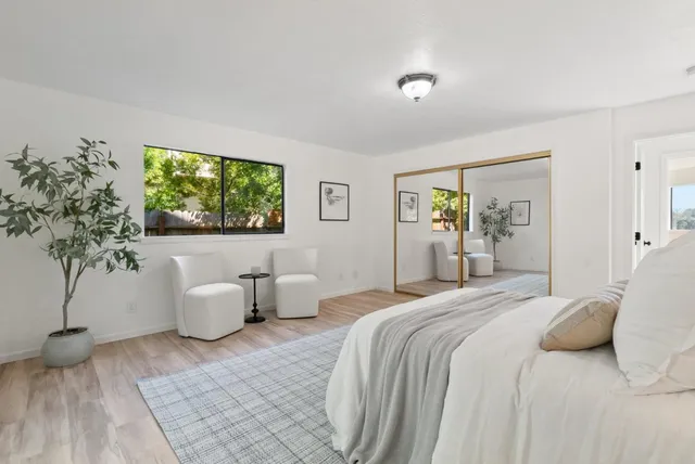 a bathroom with double vanity and a bathtub