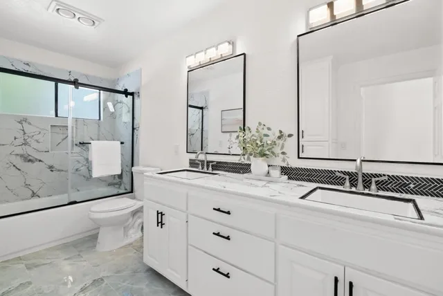 a room with white cabinets and sink