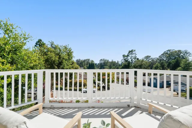 a view of a house with backyard porch and sitting area