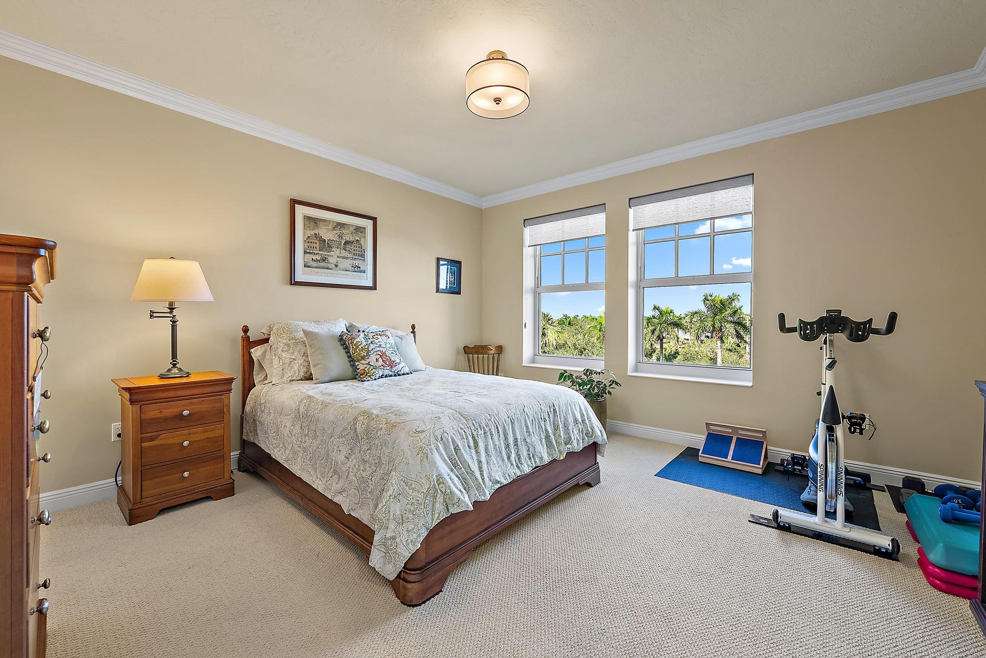 500 Highway 1, Unit 402 Jupiter, FL 33477 - Photo 24 of 38 a spacious bedroom with a bed and a window
