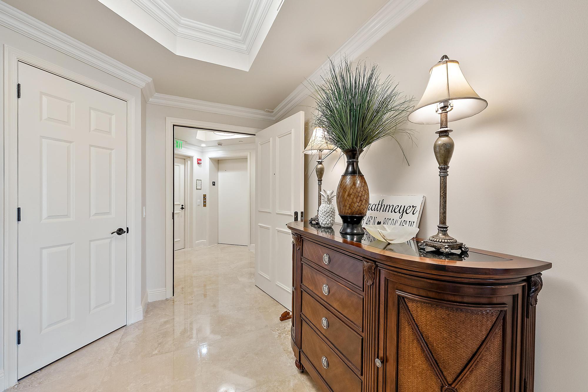 500 Highway 1, Unit 402 Jupiter, FL 33477 - Photo 27 of 38 a view of hallway with a mirror and flower pot