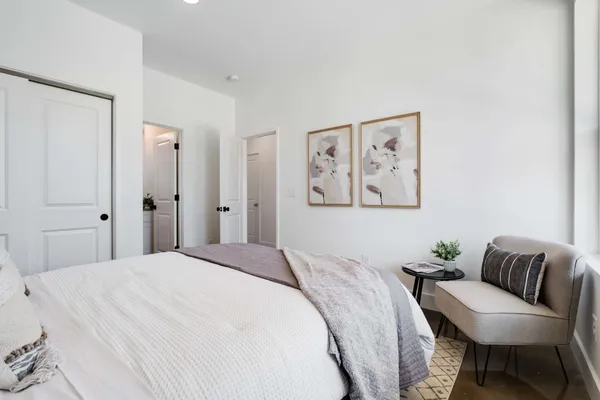 a bedroom with a large bed and a couch