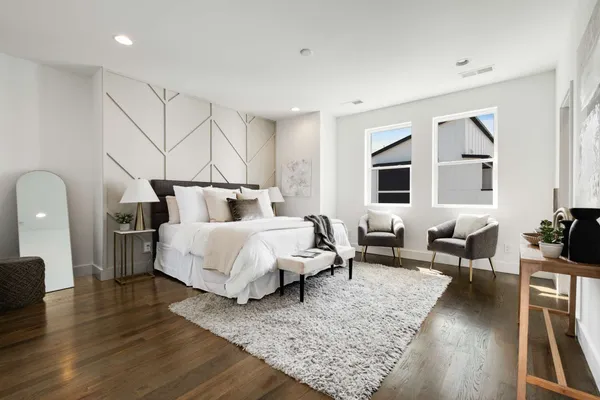 a bedroom with a bed and a view of living room