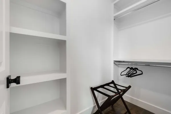 a view of a room with wooden floor and closet