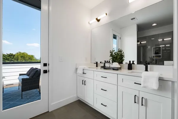 a bathroom with a glass shower door and a bathtub