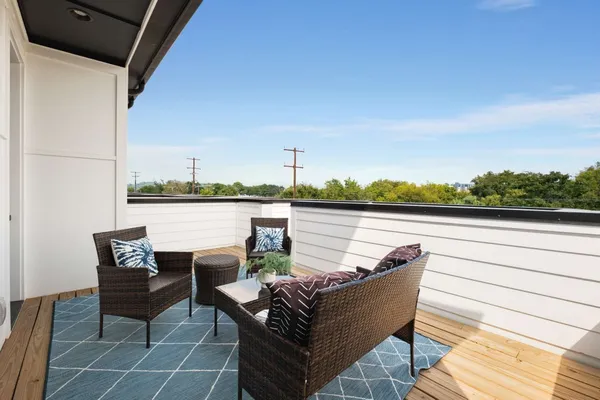 a balcony with table and chairs