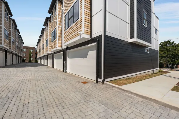 a view of a sink and dishwasher with wooden cabinets