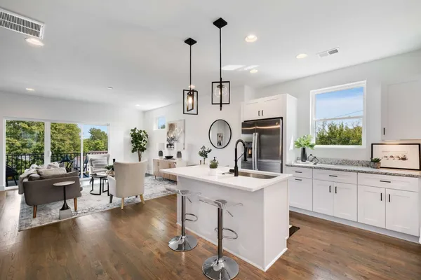 a view of center island with wooden cabinets and couch