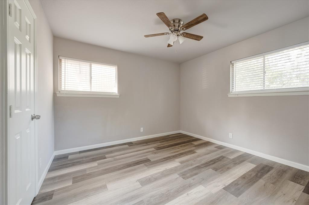 1902 Alan-A-Dale Road Arlington, TX 76013 - Photo 12 of 28 a view of a big room with wooden floor and windows