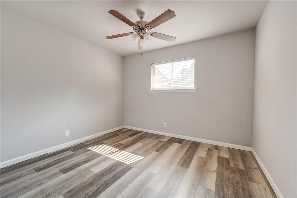 1902 Alan-A-Dale Road Arlington, TX 76013 - Photo 18 of 28 wooden floor in an empty room with a window