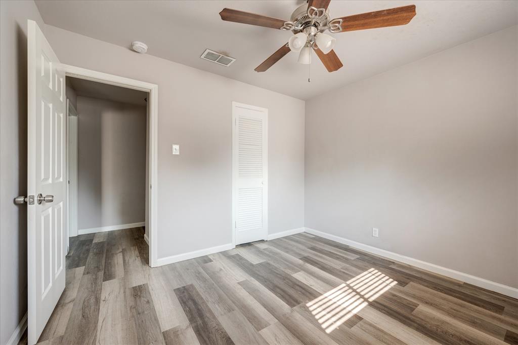 1902 Alan-A-Dale Road Arlington, TX 76013 - Photo 19 of 28 wooden floor in an empty room with a window