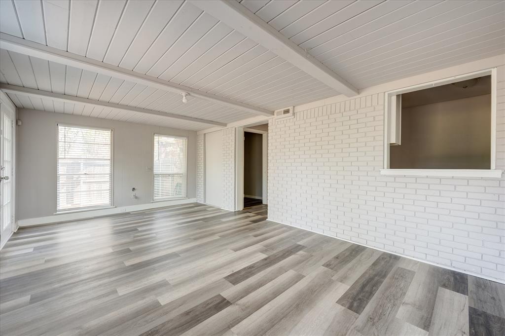 1902 Alan-A-Dale Road Arlington, TX 76013 - Photo 21 of 28 a view of an empty room with wooden floor and a window