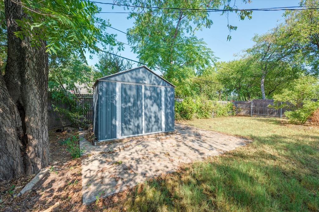1902 Alan-A-Dale Road Arlington, TX 76013 - Photo 27 of 28 a view of a small yard with large trees and wooden fence