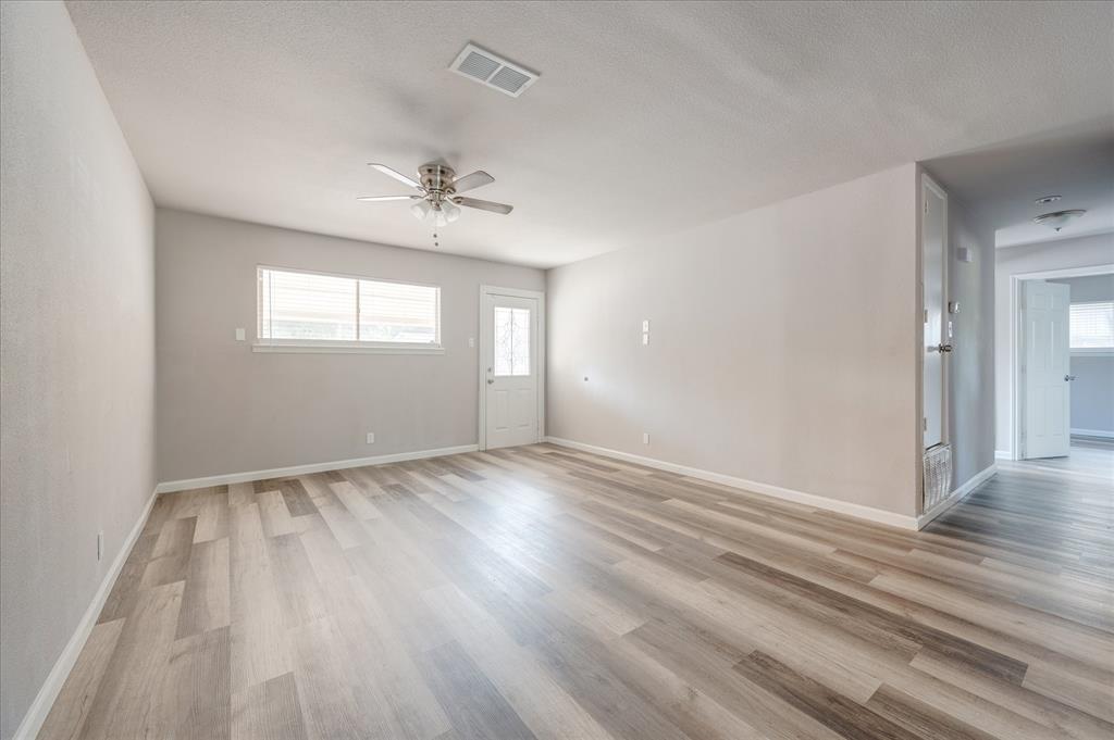 1902 Alan-A-Dale Road Arlington, TX 76013 - Photo 6 of 28 wooden floor in an empty room with a window