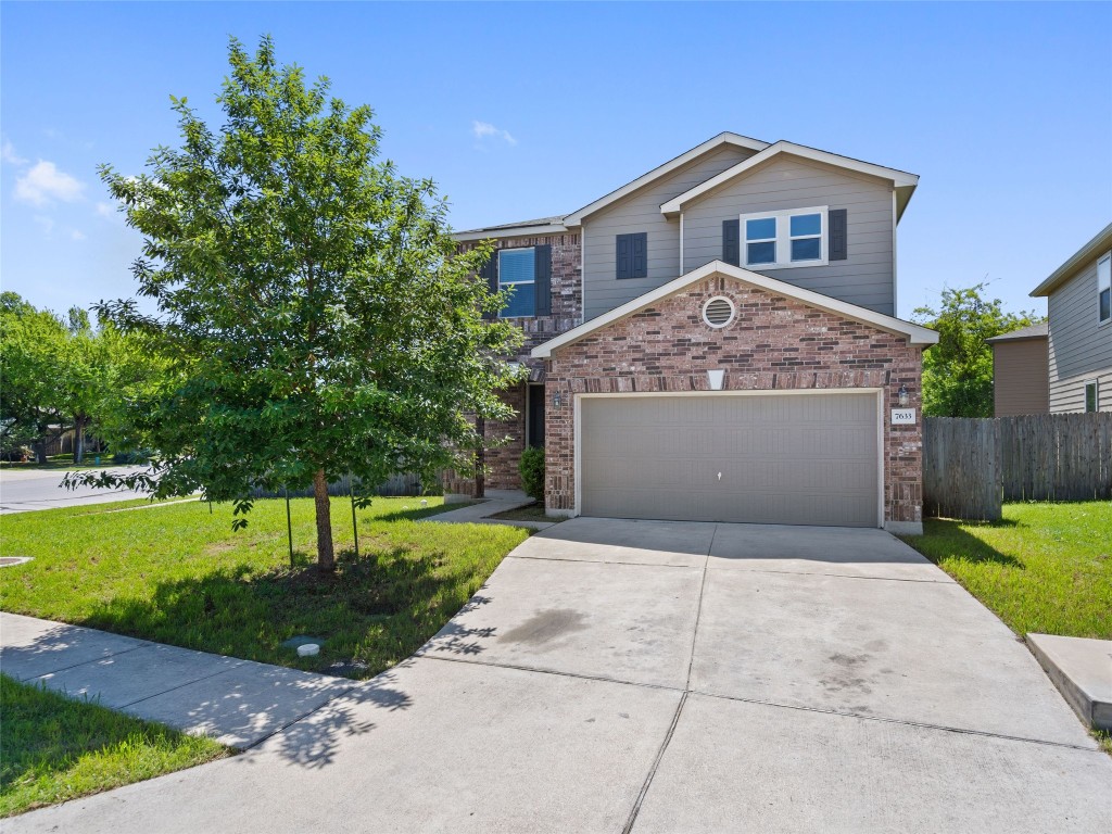 Traditional-style home with concrete driveway