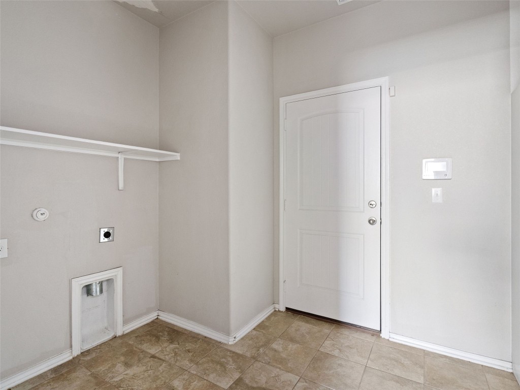7633 Rio Pass Austin, TX 78724 - Photo 11 of 23 Laundry area featuring baseboards and hookup for an electric dryer