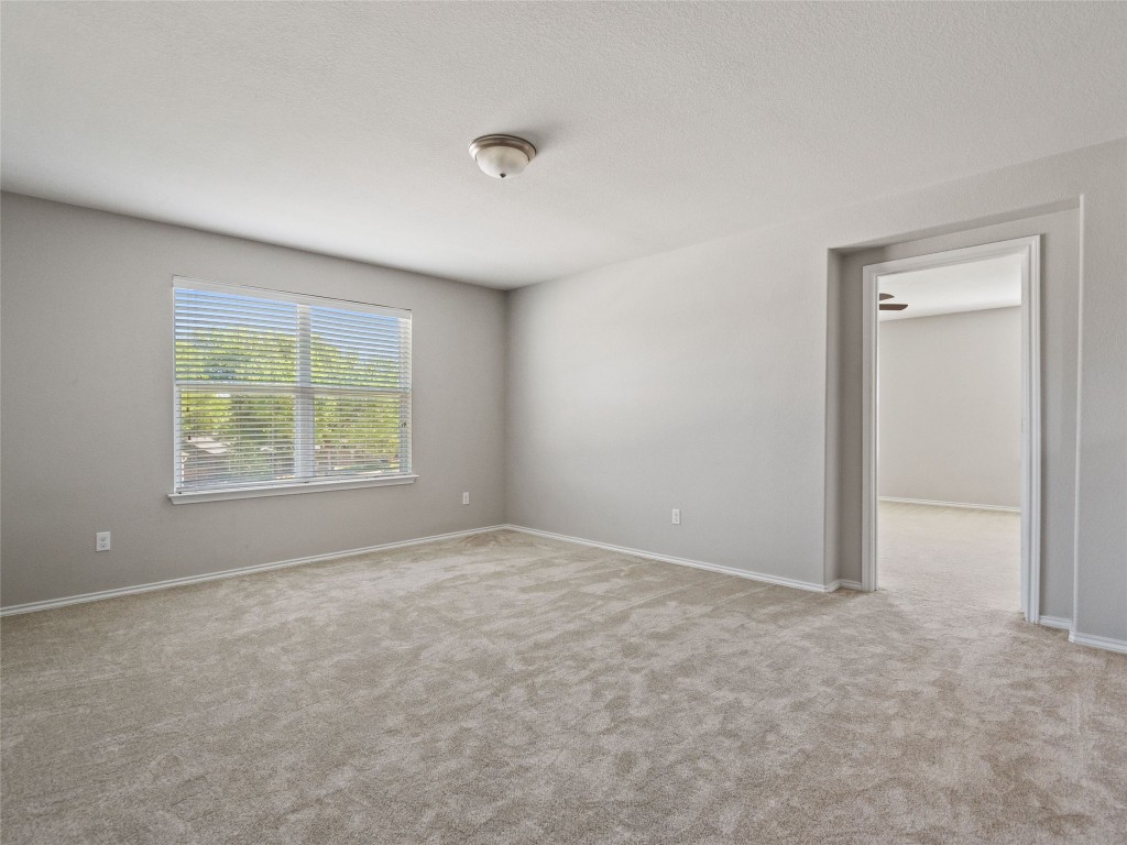 7633 Rio Pass Austin, TX 78724 - Photo 16 of 23 Spare room with light colored carpet and baseboards