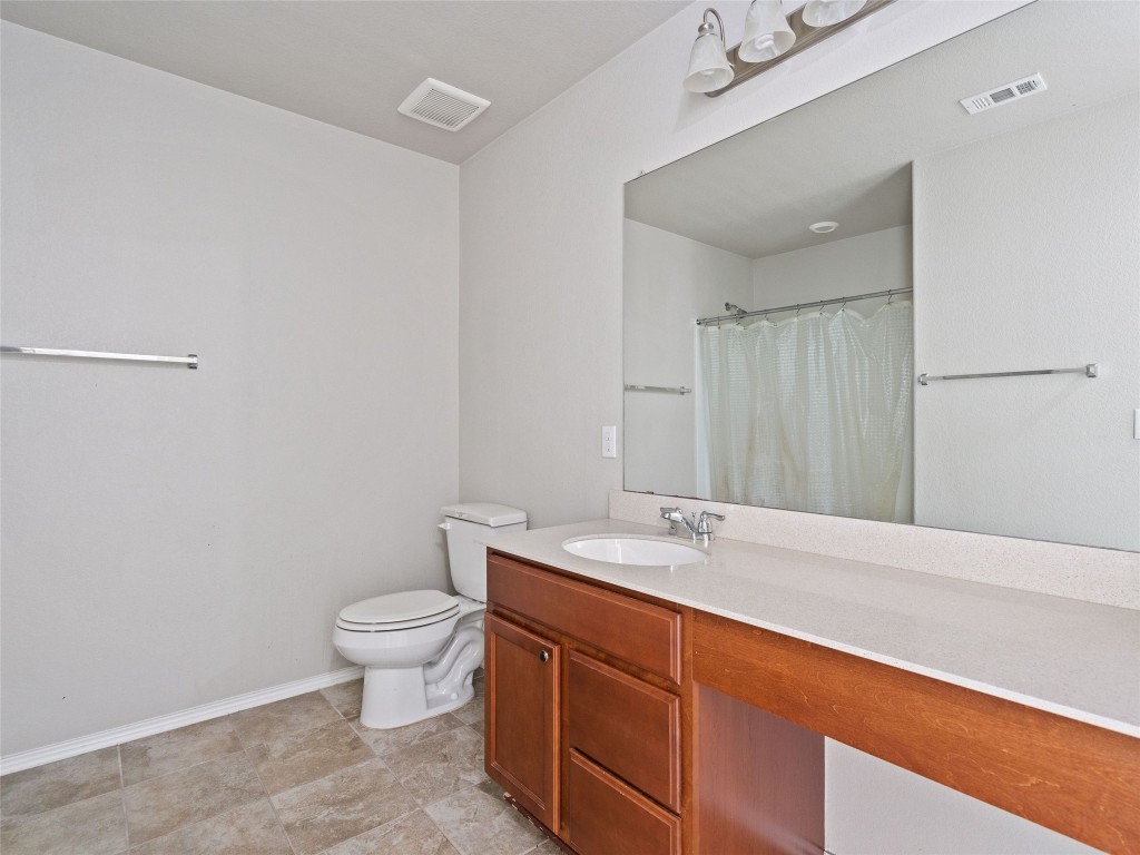 7633 Rio Pass Austin, TX 78724 - Photo 17 of 23 Bathroom with vanity and a shower with curtain