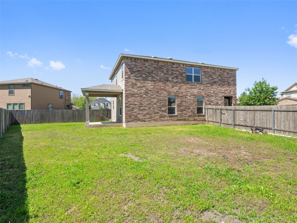 7633 Rio Pass Austin, TX 78724 - Photo 21 of 23 Back of house with a fenced backyard and brick siding