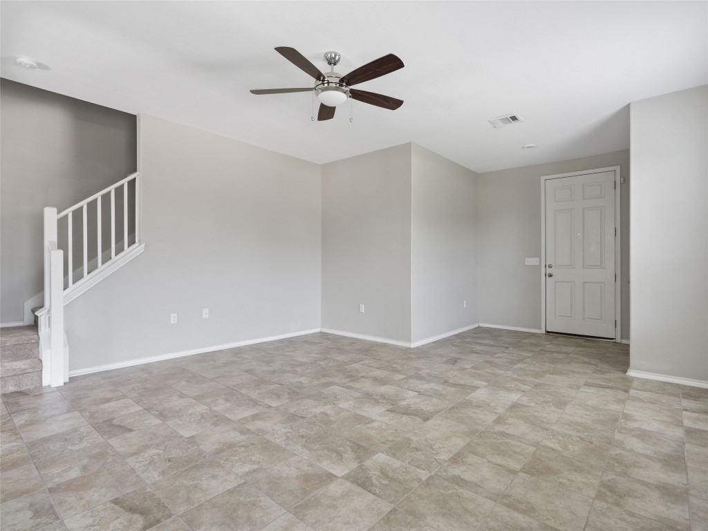 7633 Rio Pass Austin, TX 78724 - Photo 4 of 23 Empty room featuring stairs and ceiling fan