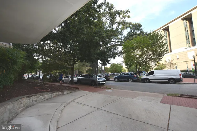 a view of cars parked on the side of a street