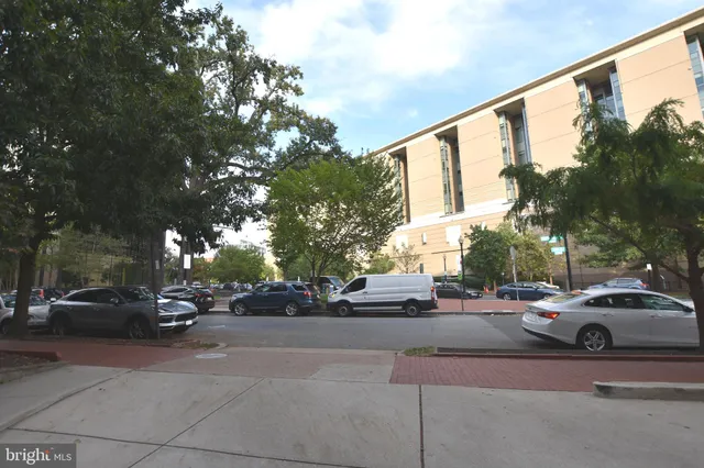 a view of a cars park in front of a building