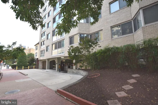 a city street lined with buildings and trees