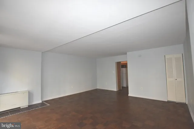 a view of a livingroom with an empty space and wooden floor