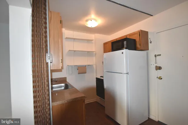 a kitchen with a refrigerator and a sink
