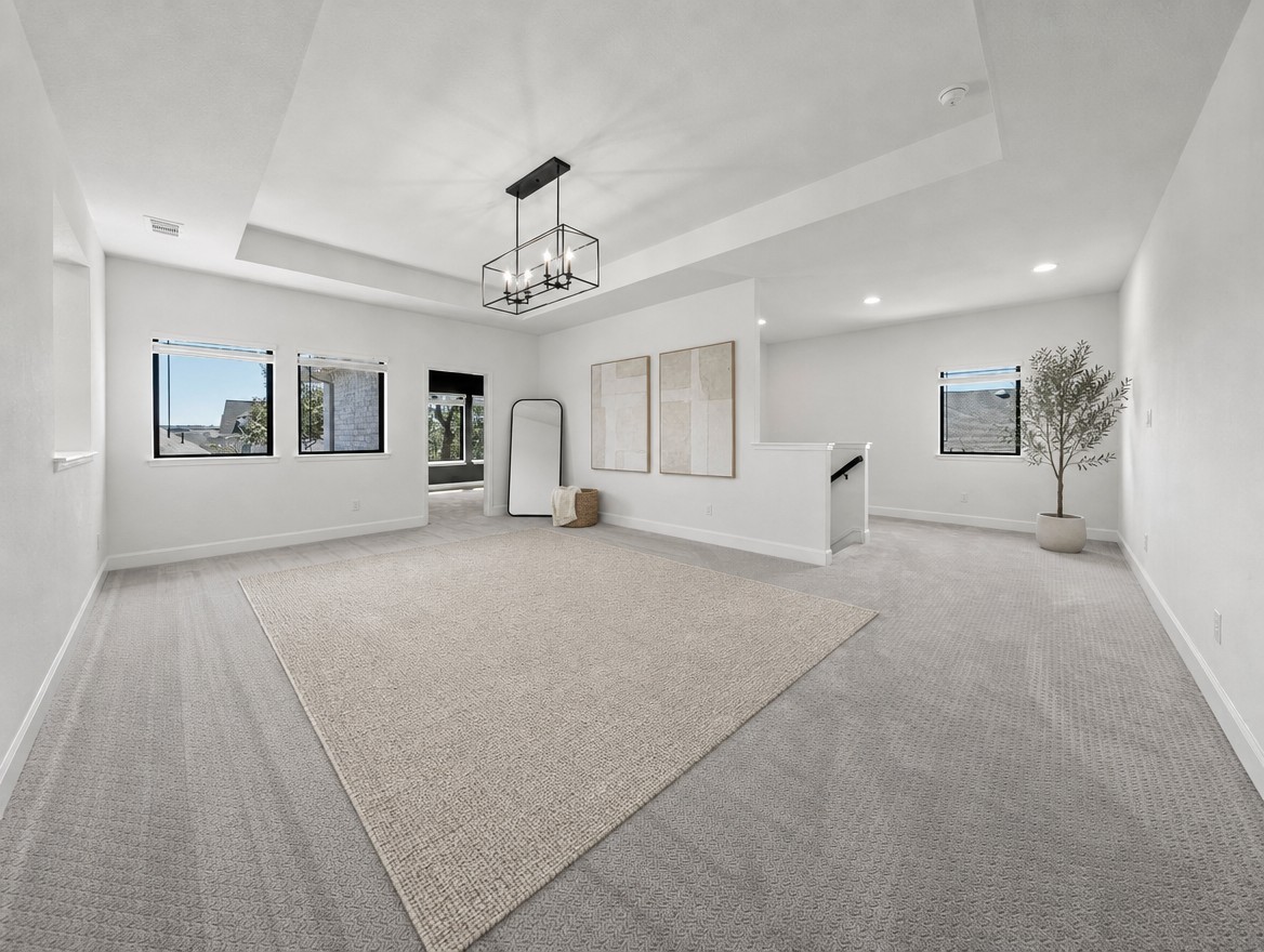 1440 Riva Ridge Drive Leander, TX 78641 - Photo 21 of 37 An airy secondary living area offers plush carpeting and a modern chandelier.