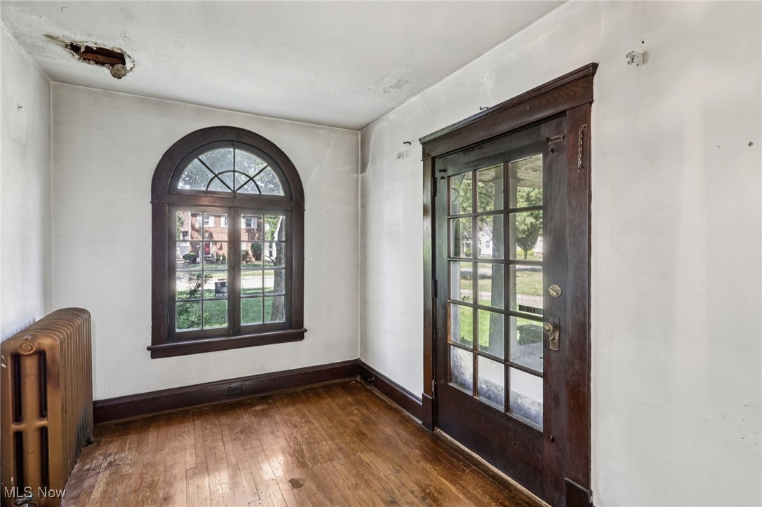 4040 Bayard Road Cleveland, OH 44121 - Photo 9 of 49 Doorway to outside with hardwood / wood-style flooring and radiator heating unit