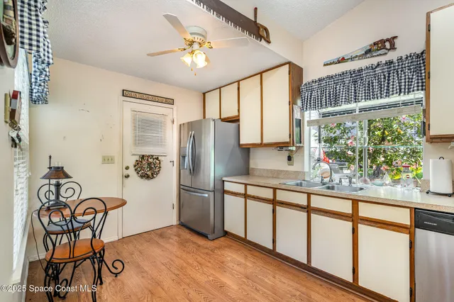 a kitchen with stainless steel appliances granite countertop a refrigerator and a stove top oven