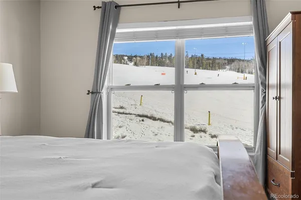 a view of a bedroom with a bed and glass window