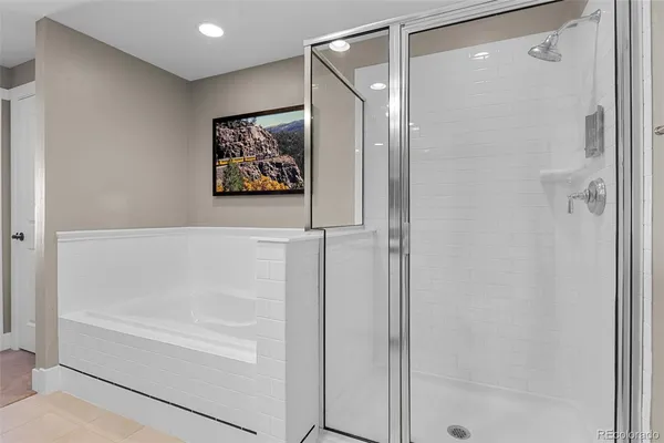 a bathroom with a painting on the wall and a shower