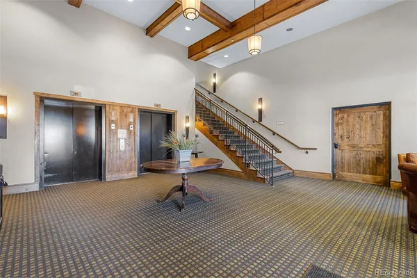 a living room with furniture a chandelier and a fireplace