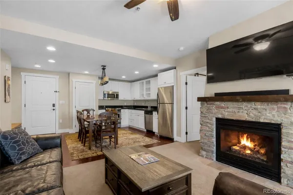 a living room with furniture and a fireplace