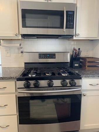 635 Townsend Road Groton, MA 01450 - Photo 8 of 40 a stove top oven sitting inside of a kitchen and granite counter tops